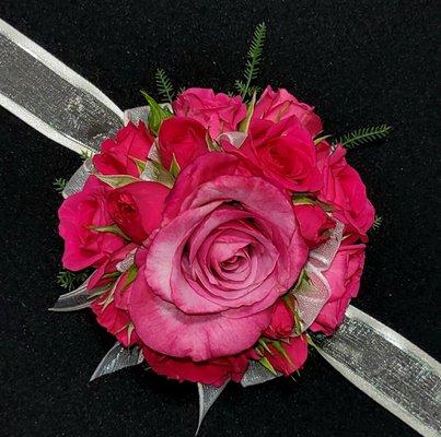 Wrist Corsage with one large rose in center, surrounded by smaller roses.