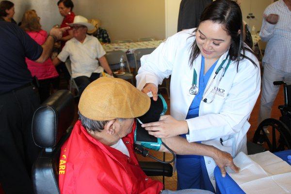 Hands-on practice at a local health fair for senior citizens.