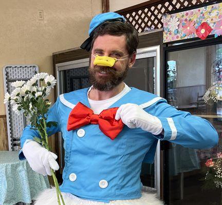 DeSoto Florist's beautiful daisies picked up by Mitch in an embarrassing Donald Duck costume.