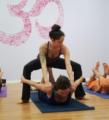 Lead Trainer, Amanda, giving a yoga assist.