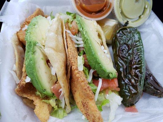 Fish tacos with a side of jalapenos