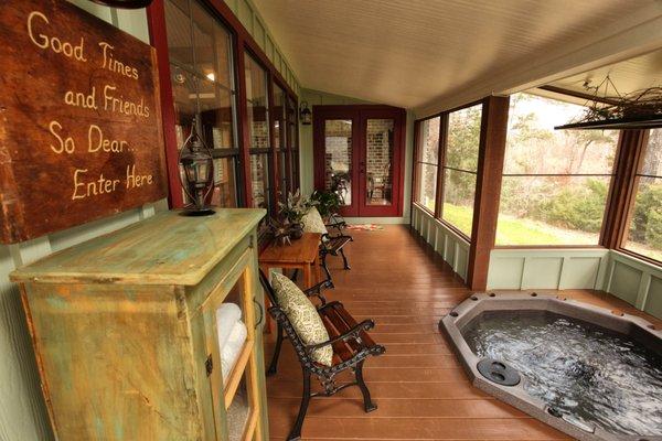 Screened in porch with hot tub.