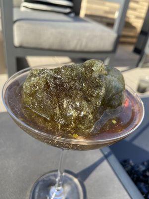 Fun cocktail with "moon rock" ice cube