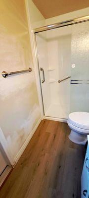 New shower and floor (Vinyl planks). Walls still need to be painted - separate Phase 2 project.