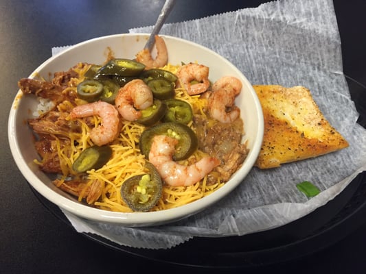 Voodoo chicken and drunken chicken over brown rice w/ shrimp, jalapeño and cheese.