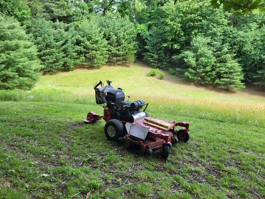 Mowing mountain property.