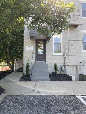 Back of office with wheelchair accessibility on left. Back door faces our parking lot. Street parking available on West 15th Street.