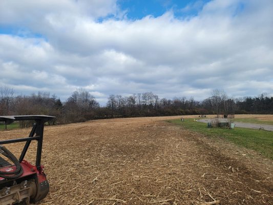 By leaving The mulch on the ground at controls erosion and suppresses weeds for a season.