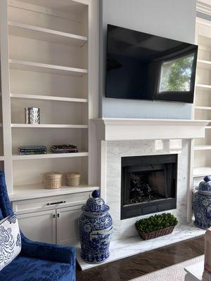 Built-in shelves and fireplace mantle.