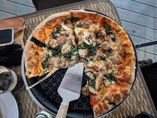 Pizza: sausage, spinach, and mushroom.