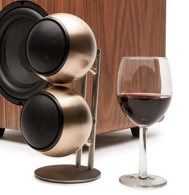 Bronze MOD2 ORB speaker on BOSS stainless steel stand.  Walnut veneer subONE behind it.