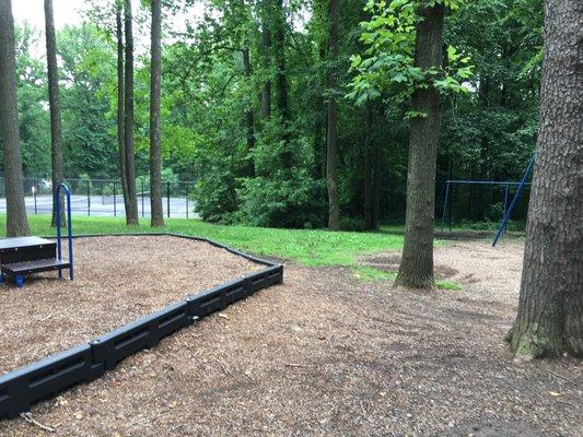 2 tennis courts down the hill from the playgrounds and swings.