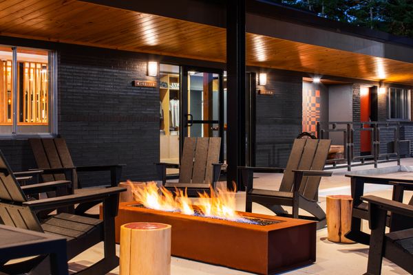 Covered front porch. Features picnic tables for dining. Fire pits and heaters during colder weather.