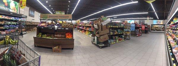 View from store corner. All produce in cases or in inviting "farmer's market" style.