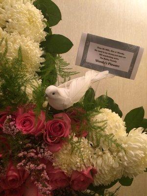 A pretty dove ensconced daintily among the flowers.