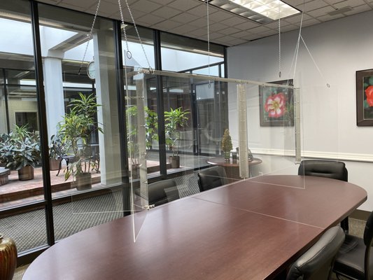 Our conference room has a plexiglass divider for the safety and health of our staff, clients, and visitors.