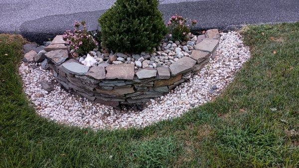 Idriveway drainage pipe planter with one to three inch River Rock and white stone