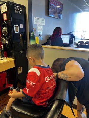 My son in the barber chair with Amanda after getting a fresh cut