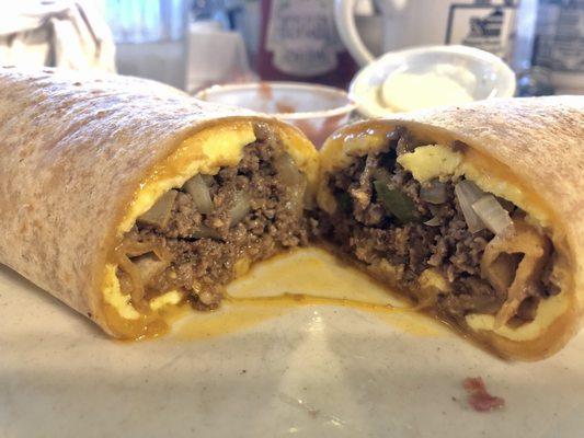 Breakfast burrito with cheddar cheese, green peppers, white onions and ground beef