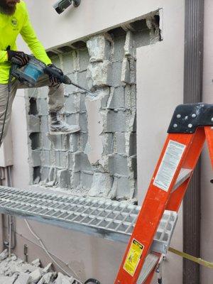 Demolition of block wall opening to insert impact sliding glass windows.