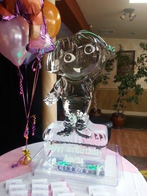 An ice sculpture of Dora the Explorer made by Apple Ice