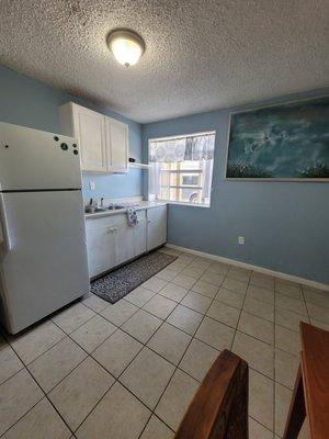 Quaint plus room 
Featuring a queen bed, kitchenette, and table