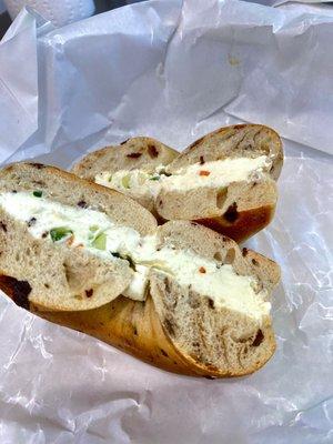 Homemade vegetable cream cheese on cinnamon raisin bagel