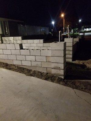 Block wall entry with pillars.