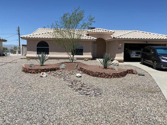 The front yard of my rental property looked rough before their transformation.