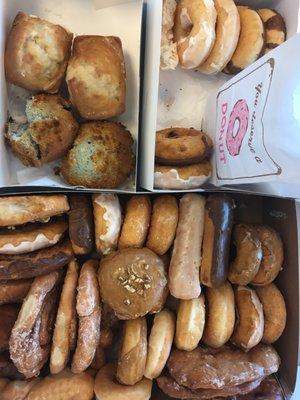 Clockwise from top: banana bread; blueberry muffin(s); and various delicious donuts.