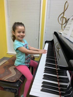 A 4 year old having fun at piano lessons