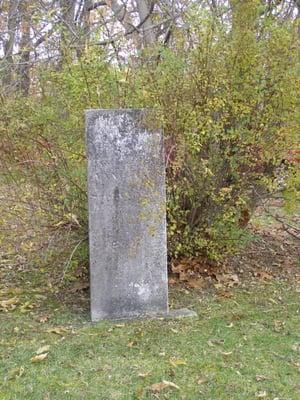 Personal pic. An old stone adorning a grave at Parshallville Cemetery.