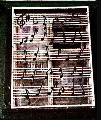 Sheet music used as a template of sorts covering a window of a San Francisco Blues Music venue, the Grant Green.