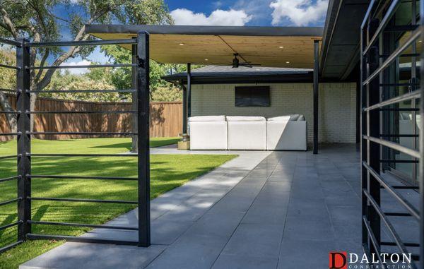 Basalt paver patio with a modern covered patio. We also installed a full back yard of artificial turf and putting green