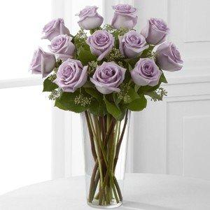 Dozen lavender roses arranged in a vase.