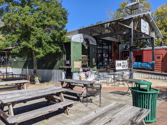 Picnic tables outside Thai Station restaurant. The restaurant uses old train cars as dining rooms.