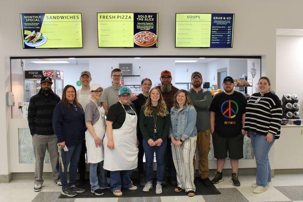 Staff from the bistro, the kitchen, maintenance and the business office pose to celebrate getting the Bistro operational. Teamwork!