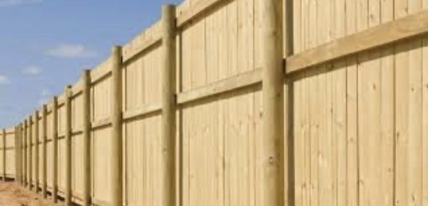 Spruce stockade fencing installation.