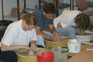 Students learn the basics of wheel-thrown pottery