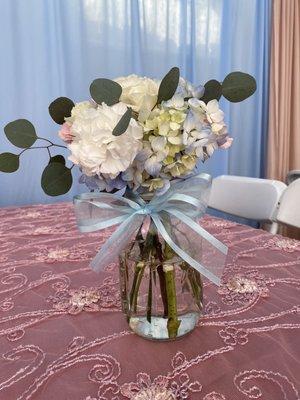 Gender reveal centerpiece with blue bow