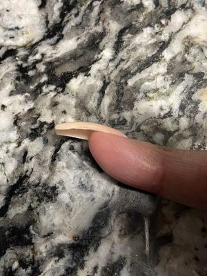 The nail was so thick, but she didn't use enough acrylic to coat the side and you can see the nail tip.