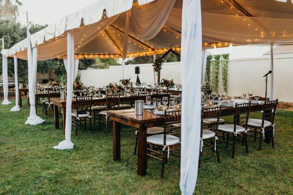 Tent, lights, draping and chairs for the reception.