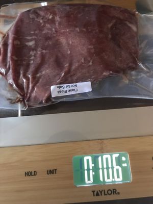 Actual packaging and weight of a cut of meat. The 0 is pounds and the right side number is ounces. A pound is 16 ounces.