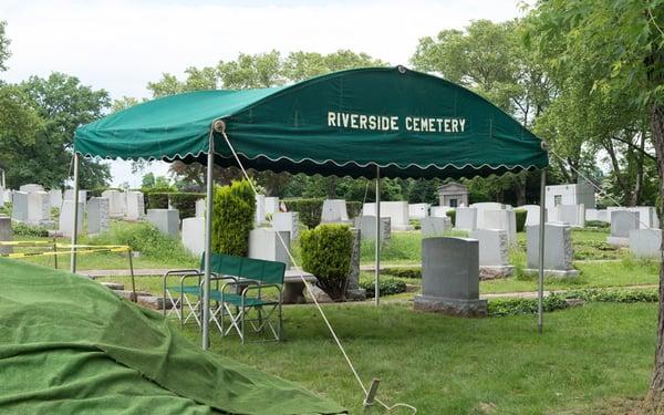 Tents provide shelter for a funeral.