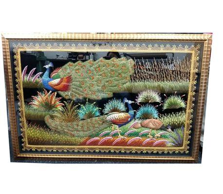 Peacock embroidery in golden frame.