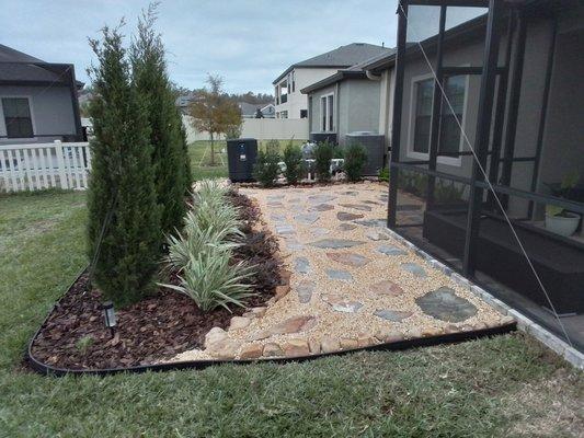 A modern landscape design with stepping stones and River rock.