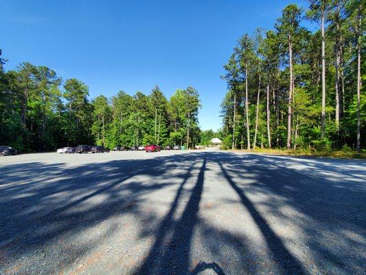 Gravel parking lot and your walk to the white building on the far side.