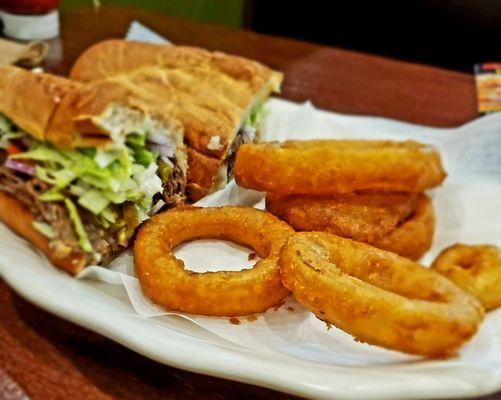 Steak and cheese sub with onion rings