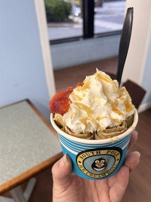 Chocolate ice cream with sweetened condensed milk, topped with whipped cream, strawberries, and caramel drizzle