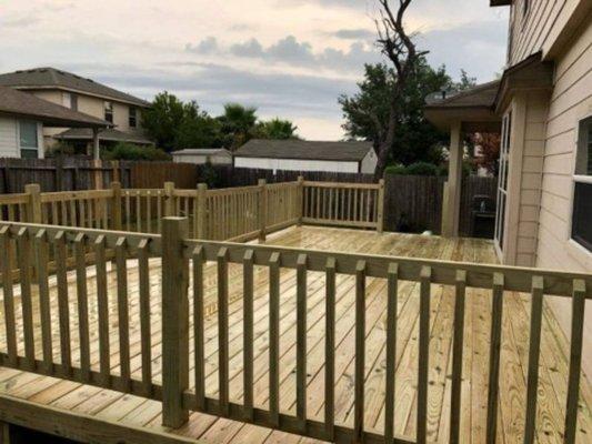 Deck with wooden baluster railing.